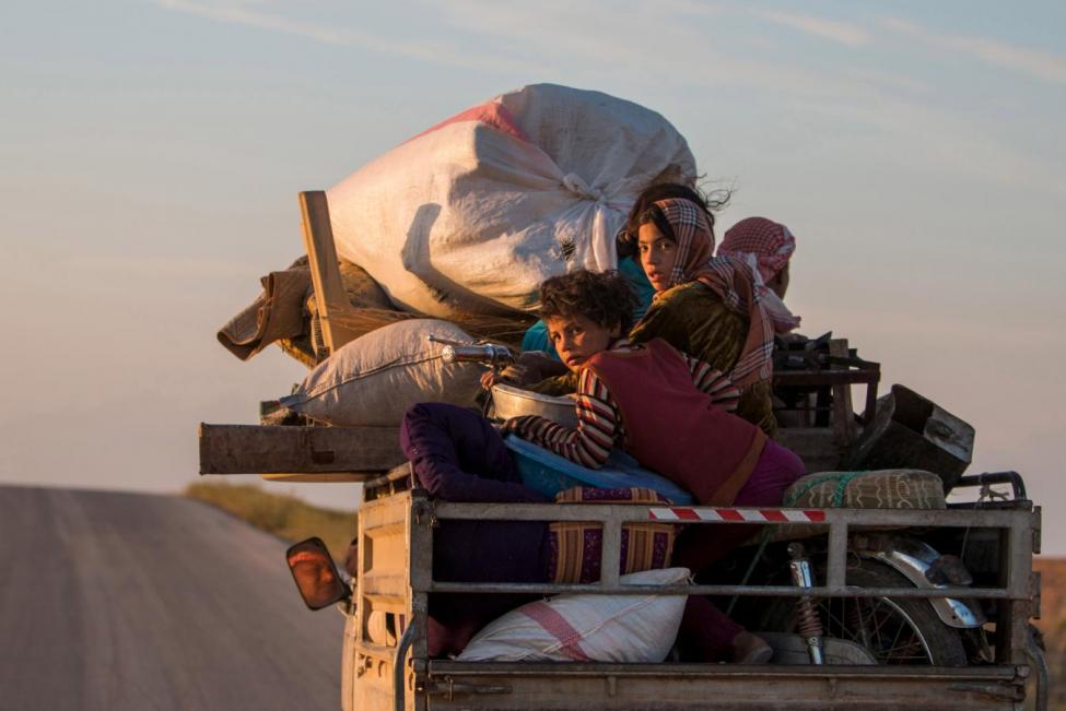 Residents, with their belongings, return to their villages on a pickup truck in the southern countryside of Ras al-Ain May 13, 2015. REUTERS/Rodi Said