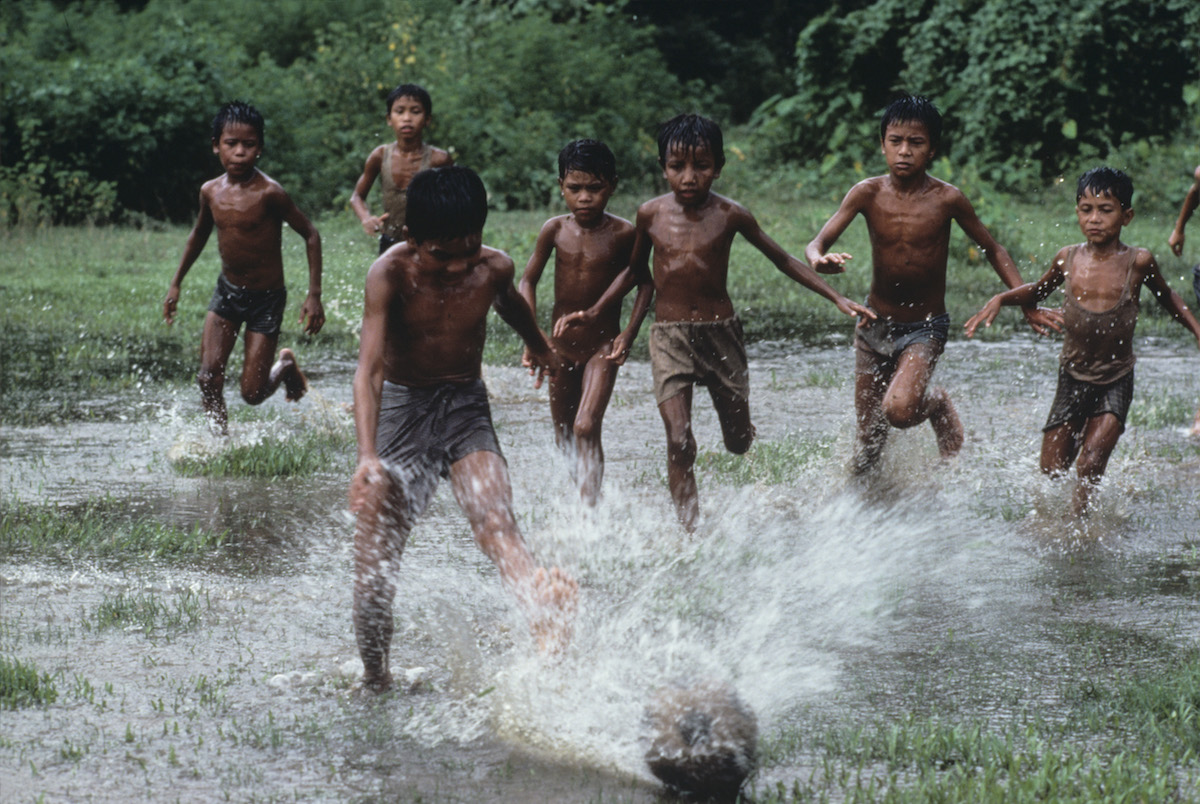 Boys playing soccer in the flooded pastures, Bangladesh, 1983